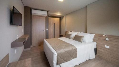 Ένα ή περισσότερα κρεβάτια σε δωμάτιο στο Quarto familia Golden Gramado Resort Laghetto