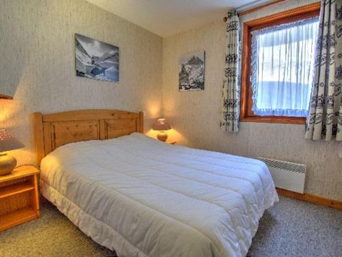 a bedroom with a large bed and a window at Appartement 3 pièces rénové, pieds des pistes et proche centre, Morzine - FR-1-524-35 in Morzine