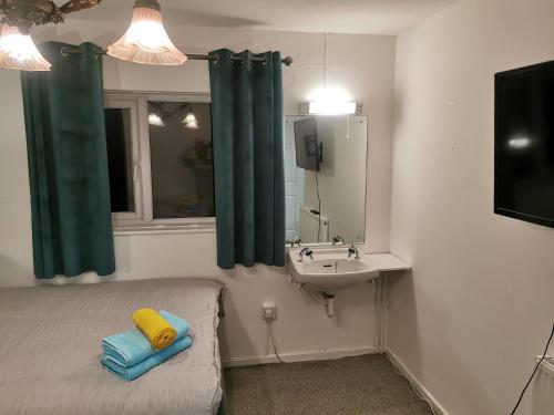 a bathroom with a bed and a sink and a mirror at 116 Maison Dieu Road Room D in Dover in Kent