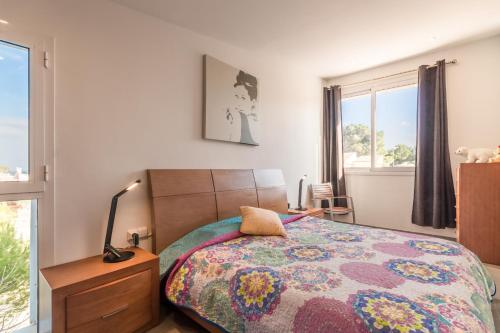 a bedroom with a bed and a lamp and a window at Son serra de marina - 27077 Mallorca in Son Serra de Marina
