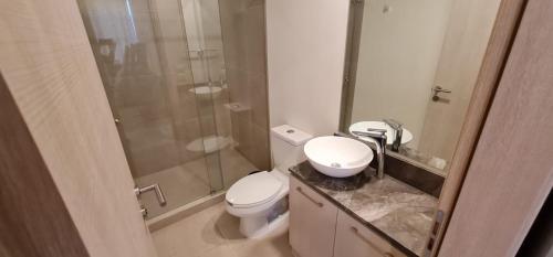 a bathroom with a toilet and a glass shower at Departamentos a 10 min de Polanco in Mexico City