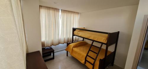 a small room with a bunk bed and a window at Departamentos a 10 min de Polanco in Mexico City