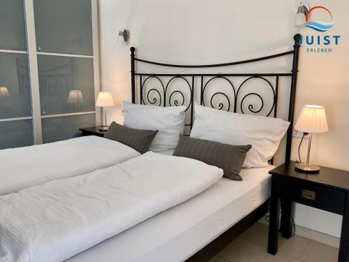 a bedroom with two beds with white pillows at Landhaus Gertrude 106 - Wohnung Ida in Juist