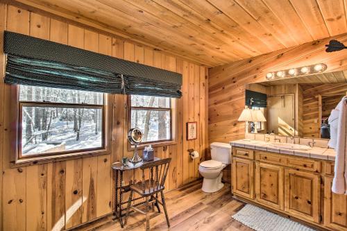 ein Blockhausbad mit einem Waschbecken und einem WC in der Unterkunft Pinetop Cabin with Private Patio on Eighth Green! in Indian Pine