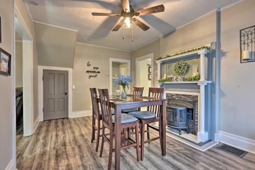 a dining room with a table and chairs and a fireplace at Niagara Falls Townhome Near Wineries! in Niagara Falls
