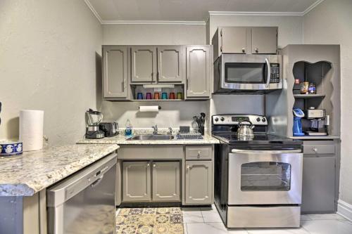 a kitchen with stainless steel appliances and white cabinets at Niagara Falls Townhome Near Wineries! in Niagara Falls