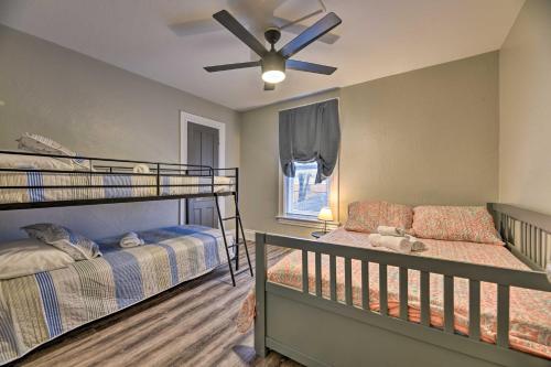 a bedroom with two bunk beds and a ceiling fan at Niagara Falls Townhome Near Wineries! in Niagara Falls