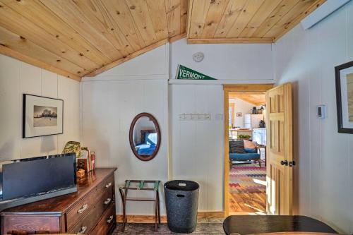 a living room with a tv and a wooden ceiling at Hiking Trails On-Site Cozy Falls Brook Cabin in Williamsville Station