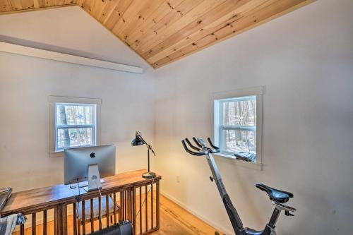 a room with a treadmill and a desk with a computer at Hiking Trails On-Site Cozy Falls Brook Cabin in Williamsville Station