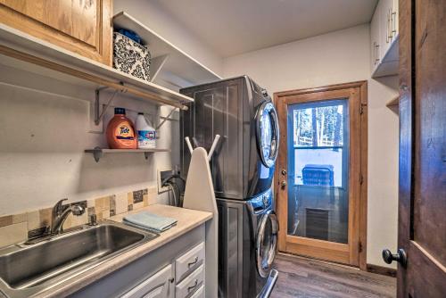 a kitchen with a stainless steel refrigerator and a sink at Expansive Evergreen Home with Hot Tub and Deck! in Evergreen