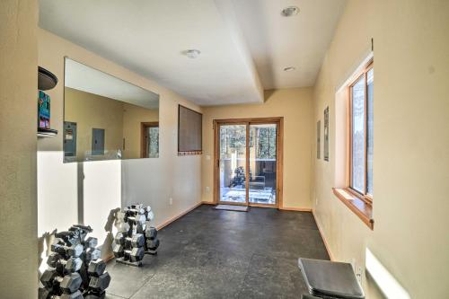 a room with a gym with chairs in it at Expansive Evergreen Home with Hot Tub and Deck! in Evergreen