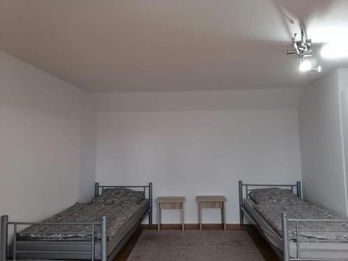 two bunk beds in a room with two tables at Naab-Wohn in Nabburg