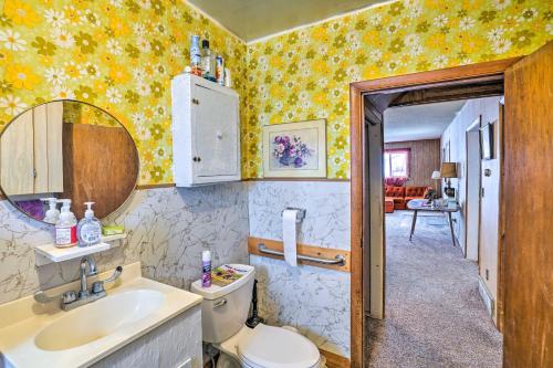 a bathroom with a toilet and a sink and a mirror at Charming Corral Creek Ranch House in Circle in Circle