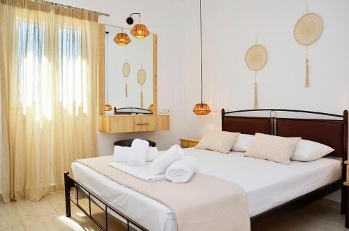 a bedroom with two beds with white towels on them at Louros rooms in Koufonisia