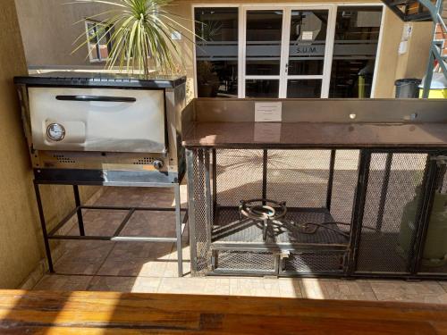 a table with a toaster on top of it at MIRALEJOS 6 CENTRO in Villa Carlos Paz