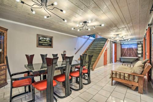 a dining room with a table and chairs and a staircase at Pet-Friendly Bartlett Farmhouse with Deck! in Bartlett