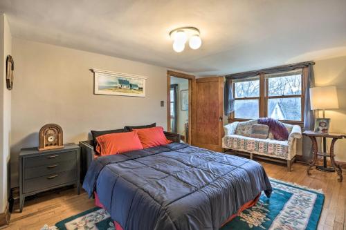 a bedroom with a bed with orange pillows and a window at Pet-Friendly Bartlett Farmhouse with Deck! in Bartlett
