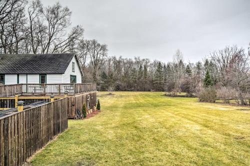 a yard with a house and a fence at Pet-Friendly Bartlett Farmhouse with Deck! in Bartlett