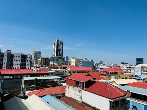 a group of buildings with red roofs in a city at Chung Hsin Hotel 中信酒店 in Phnom Penh