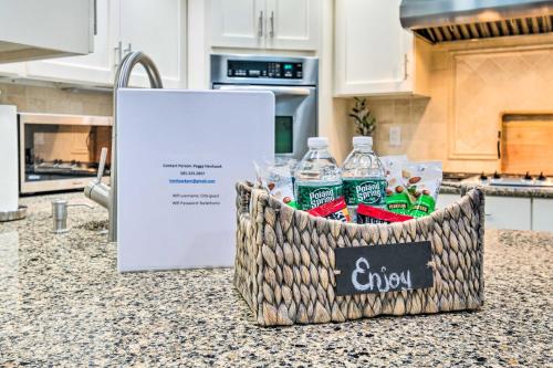 a basket of water bottles on a counter in a kitchen at Spacious Rochester Home with Heated Pool and Hot Tub! in Rochester