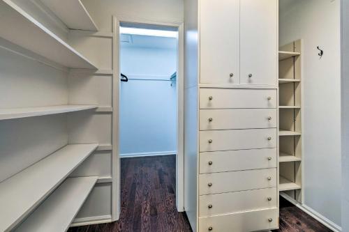 a walk in closet with white cabinets and a backdoor at Spacious Rochester Home with Heated Pool and Hot Tub! in Rochester