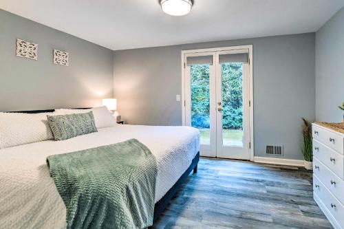 a bedroom with a bed and a glass door at Spacious Rochester Home with Heated Pool and Hot Tub! in Rochester