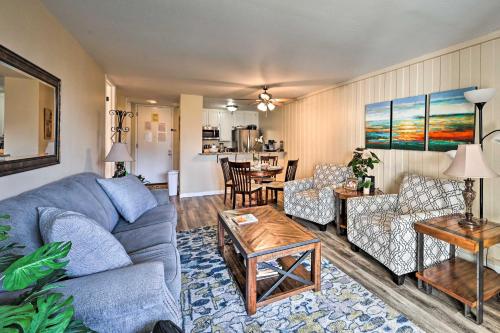 a living room with a blue couch and a table at Deja Blue Oceanside Condo on Beach with Pools! in Oceanside