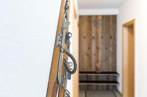 a wooden door with a chain in front of a hallway at Haus Raich in Arzl im Pitztal