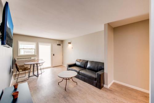 a living room with a leather couch and a table at Taos Motor Lodge in Taos