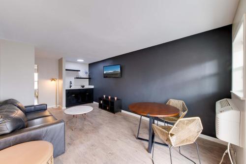a living room with a couch and a table and chairs at Taos Motor Lodge in Taos