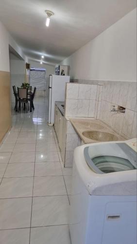 a kitchen with a toilet in the middle of a room at RECANTO DO LUAR in Piranhas