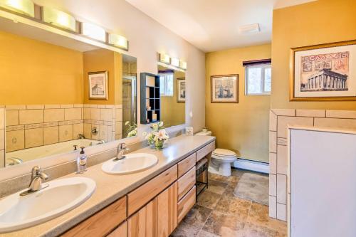 a bathroom with two sinks and a tub and a toilet at Hillside Anchorage Home by Hiking and Biking Trails! in Anchorage