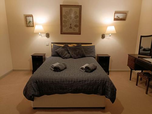 a bedroom with a bed with two towels on it at Pandy Barn Berriew in Welshpool