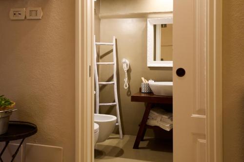a bathroom with a toilet and a sink and a mirror at Borgo San Gaetano in Bernalda