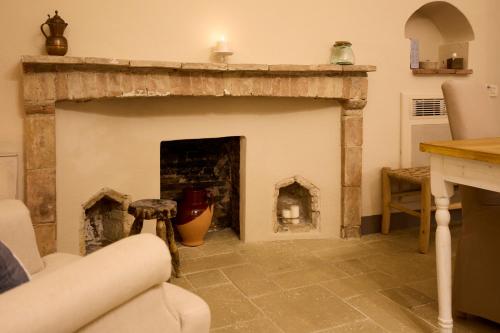 a living room with a fireplace and a couch at Borgo San Gaetano in Bernalda