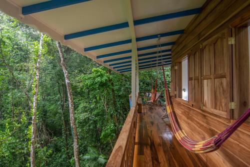 a hammock on a house in the woods at Blue Maverick Retreat - Secluded Nature Escape - 4WD Access Required in Cocles