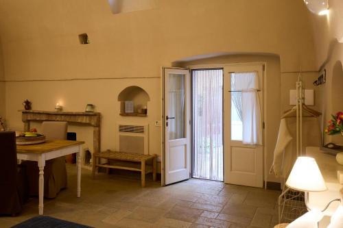 a room with a door and a table and a desk at Borgo San Gaetano in Bernalda