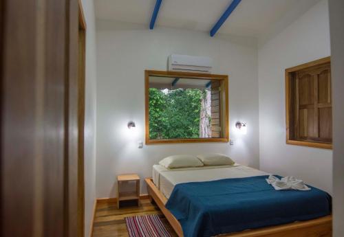 a bedroom with a bed and a window at Blue Maverick in Playa Cocles 4x4 neccesary in Cocles