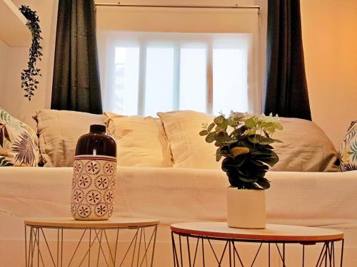 a living room with a couch and two tables at Casa del Castillo by Naturadrada in La Adrada