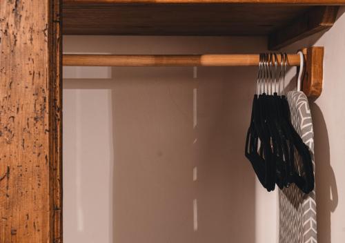a group of black utensils hanging on a shelf at El Edén Hotel Boutique in Pátzcuaro