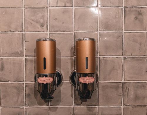 two brown cups sitting on a tiled floor at El Edén Hotel Boutique in Pátzcuaro