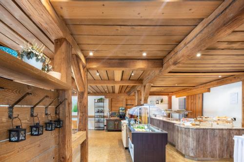 a large kitchen with wooden walls and wooden ceilings at Garner Hotel Erlangen Süd by IHG in Erlangen