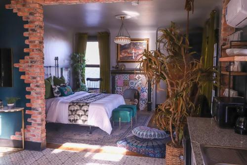 a bedroom with a bed and a brick wall at Casa Mina #3 Central Rio Grande Historic Dist in El Paso