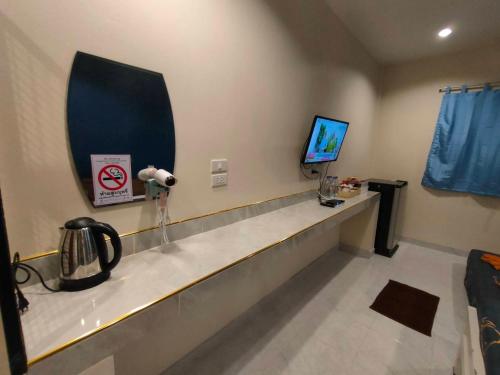 a hospital room with a counter and a tv at Banana Resort Sadao in Sadao
