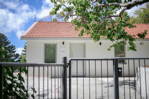 a white house with a gate in front of it at Legacy 1930s in Prodromos