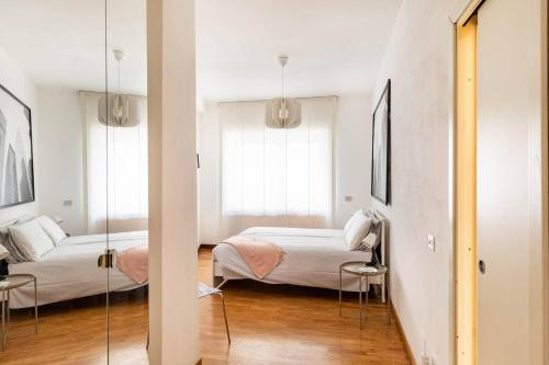 1 dormitorio con 2 camas y espejo. en 7GF HOME, en Roma