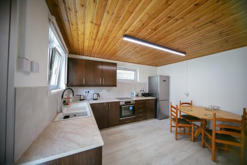 a kitchen with a table and a wooden ceiling at Legacy 1930s in Prodromos