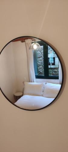 a mirror reflecting a bed in a room at Kristi's Homes - "Beautiful Home" in Dimitsana in Dhimitsana