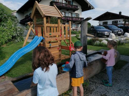 a group of children playing in a wooden playset at Matheishof inkl. Chiemgaukarte in Ruhpolding