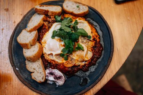 a plate of food with bread on a table at Boulenc Bed and Bread in Oaxaca City